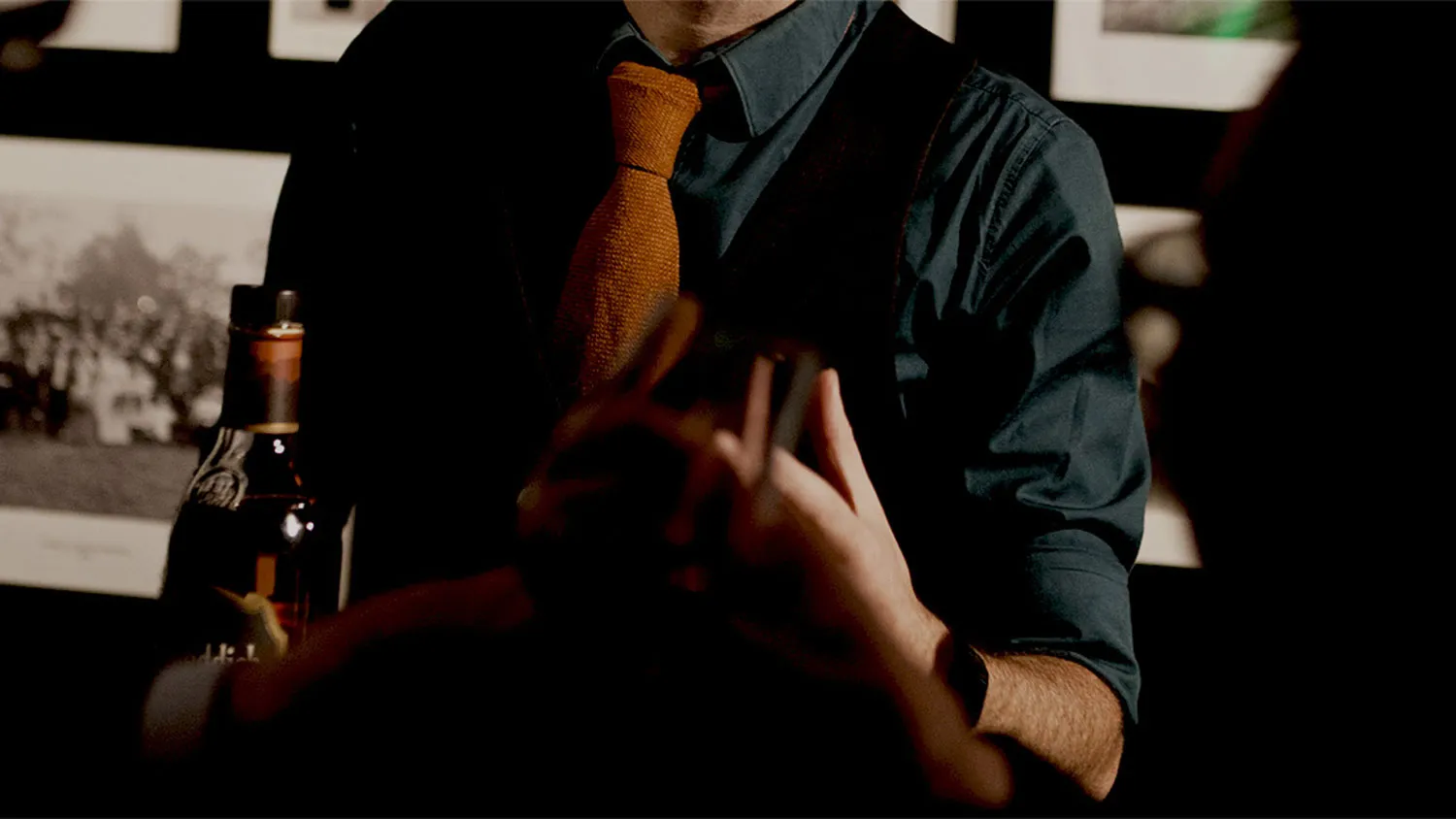 Man in shirt and tie holding whisky bottle 